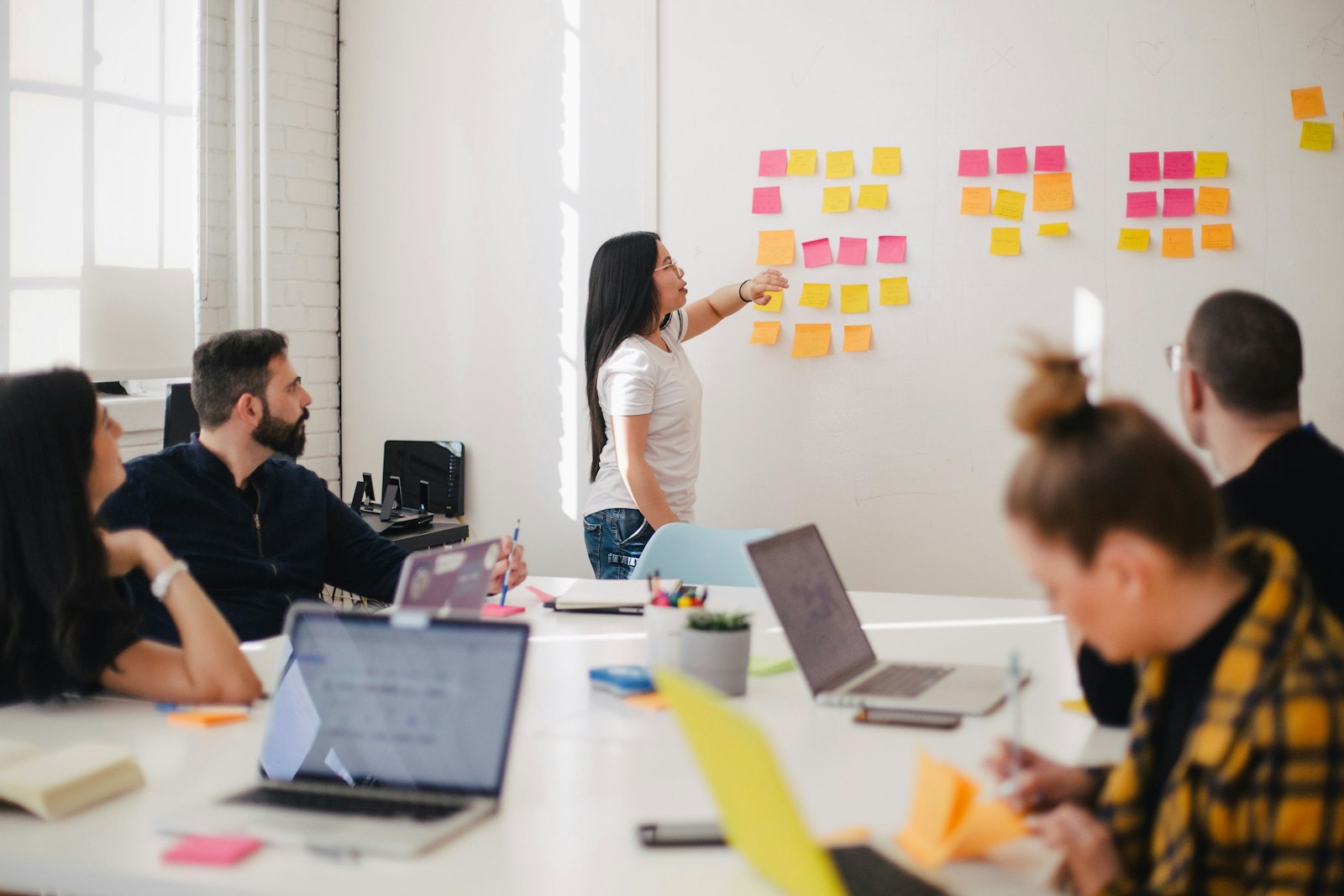 PitchMotion team reviewing campaign strategy in a graphite meeting room